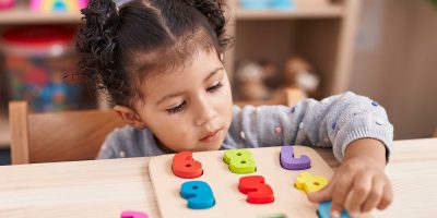 kid observing or studying educational globe model in the classr